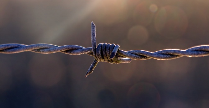 Ein Stacheldraht ist als Symbol für eine Abgrenzung zu sehen