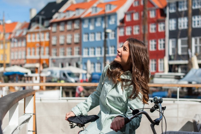 Frau mit Fahrrad auf Urlaub in Dänemark