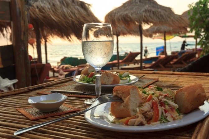 Vor einer mediterranen Kulisse liegt Essen auf dem Tisch