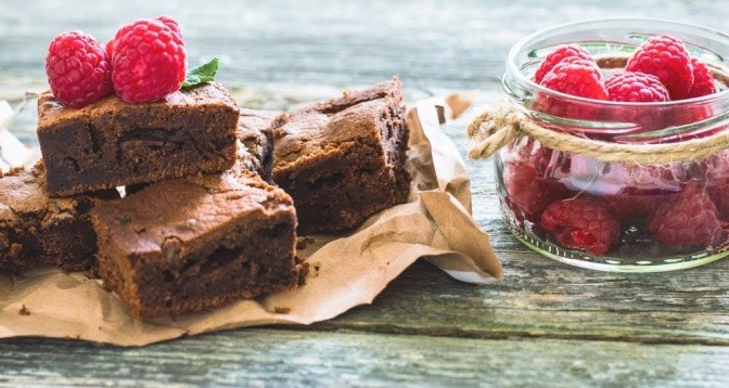 Ein paar Brownies mit Heidelbeeren als Dekoration.