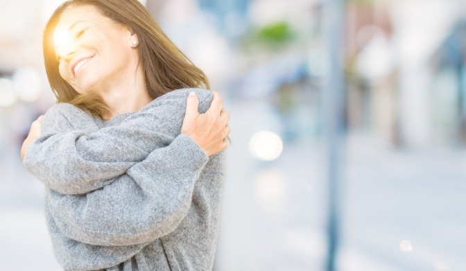 Eine Frau lacht und fühlt sich wohl bei schönem Wetter