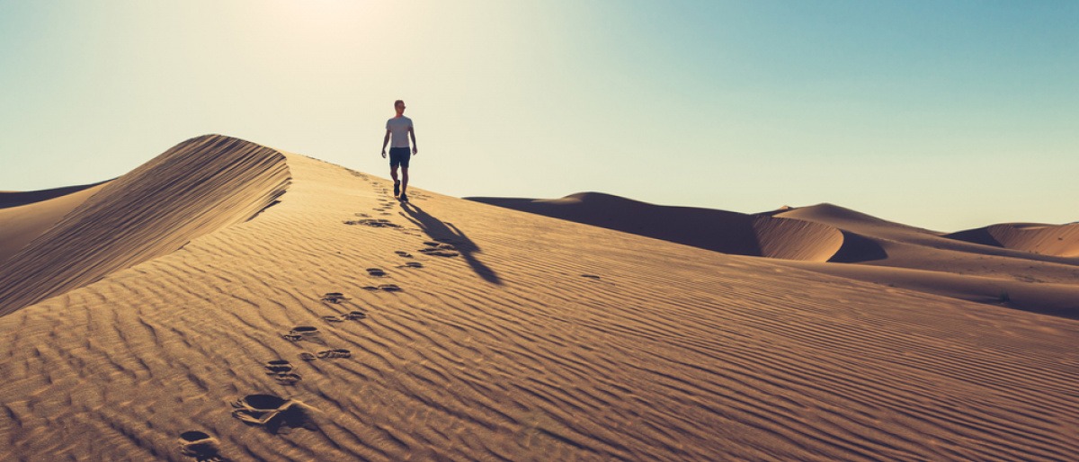 Fußspuren im Sand als Symbol für Gehmeditation